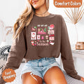 Comfort Colors Ho Ho Ho ’Tis The Season long sleeve Christmas shirt featuring a festive holiday graphic on a relaxed garment-dyed 100% cotton tee in Espresso