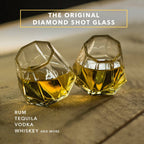 Set of clear diamond-shaped 2 oz shot glasses by Dragon Glassware featuring a unique geometric design that rests at a tilted angle.