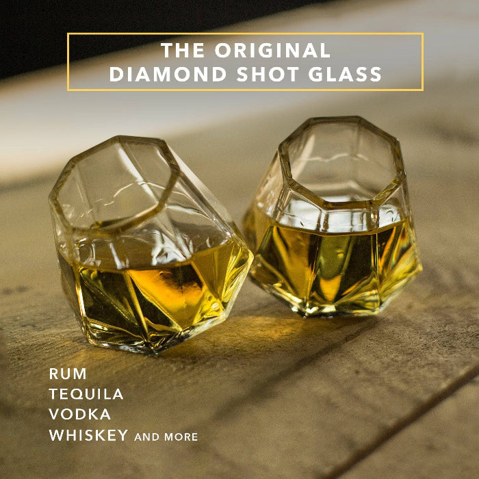 Set of clear diamond-shaped 2 oz shot glasses by Dragon Glassware featuring a unique geometric design that rests at a tilted angle.