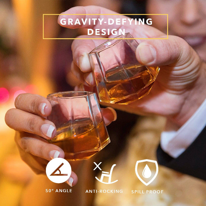 Set of clear diamond-shaped 2 oz shot glasses by Dragon Glassware featuring a unique geometric design that rests at a tilted angle.