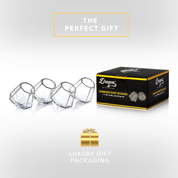 Set of clear diamond-shaped 2 oz shot glasses by Dragon Glassware featuring a unique geometric design that rests at a tilted angle.