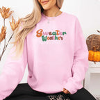 Sweater Weather Fall Vibes unisex crewneck sweatshirt featuring a cozy autumn-inspired graphic design for fall in Pink.